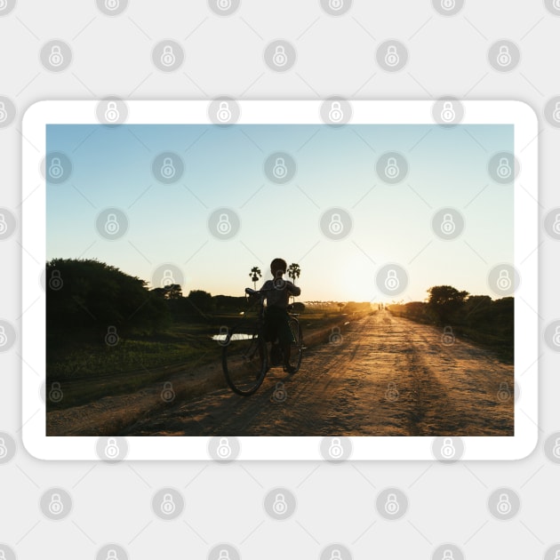 Silhouette of Boy Riding Bicycle at Sunset in Burmese Countryside Sticker by visualspectrum